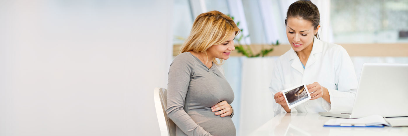 Pregnant woman talking with doctor